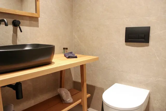 Detail of a black basin on a wooden vanity