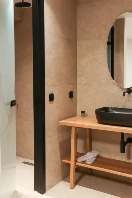 Wooden vanity with a black basin and black tap fittings