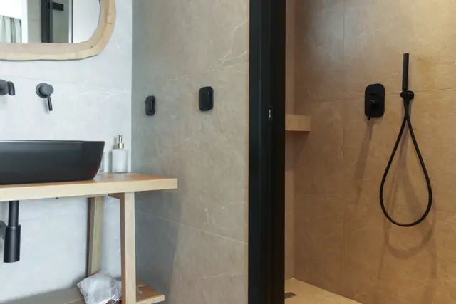 En-suite vanity and shower detail with black fittings