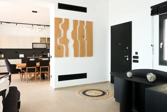 Entrance and living area with the open-plan kitchen behind