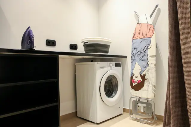 Laundry area with a washing machine and worktop
