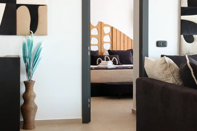 Living area with a view into the main bedroom
