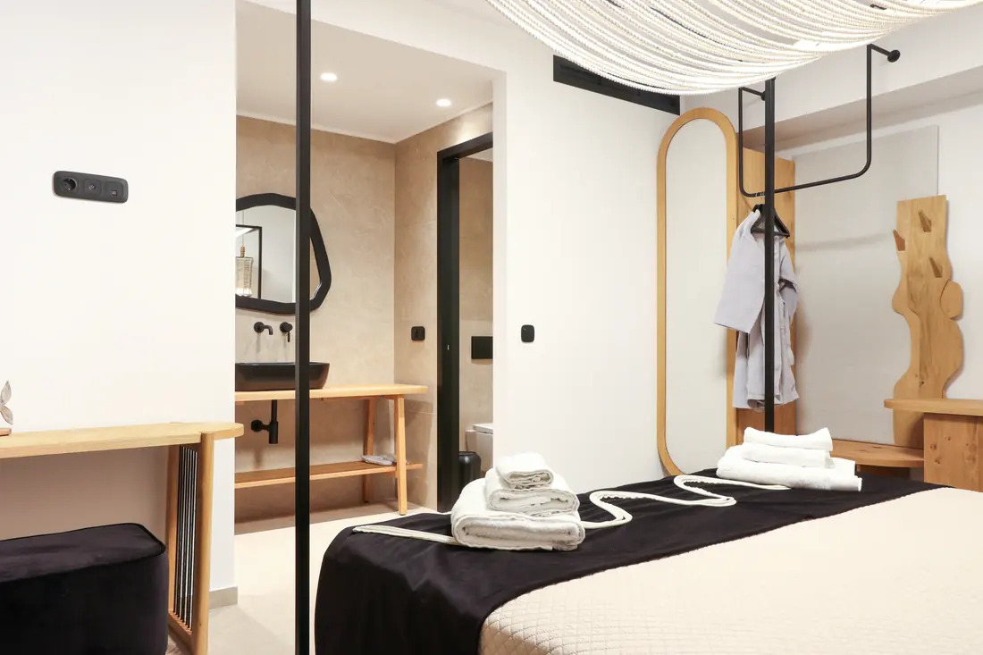 Bedroom with draped canopy ceiling and a black-and-white bed runner