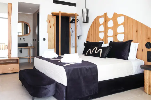 Main bedroom with a double bed and sculpted wooden headboard