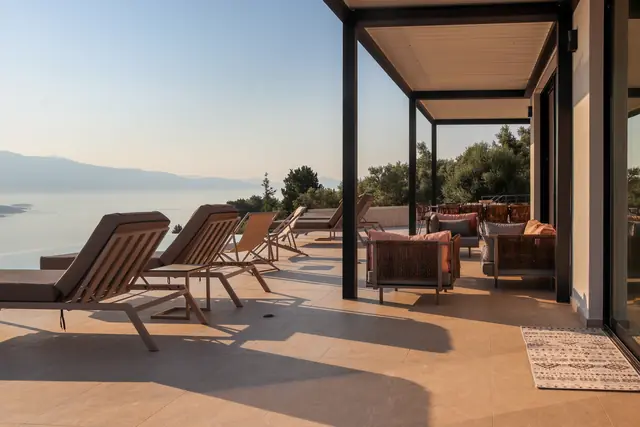 Pool terrace with sun loungers overlooking the Ionian Sea